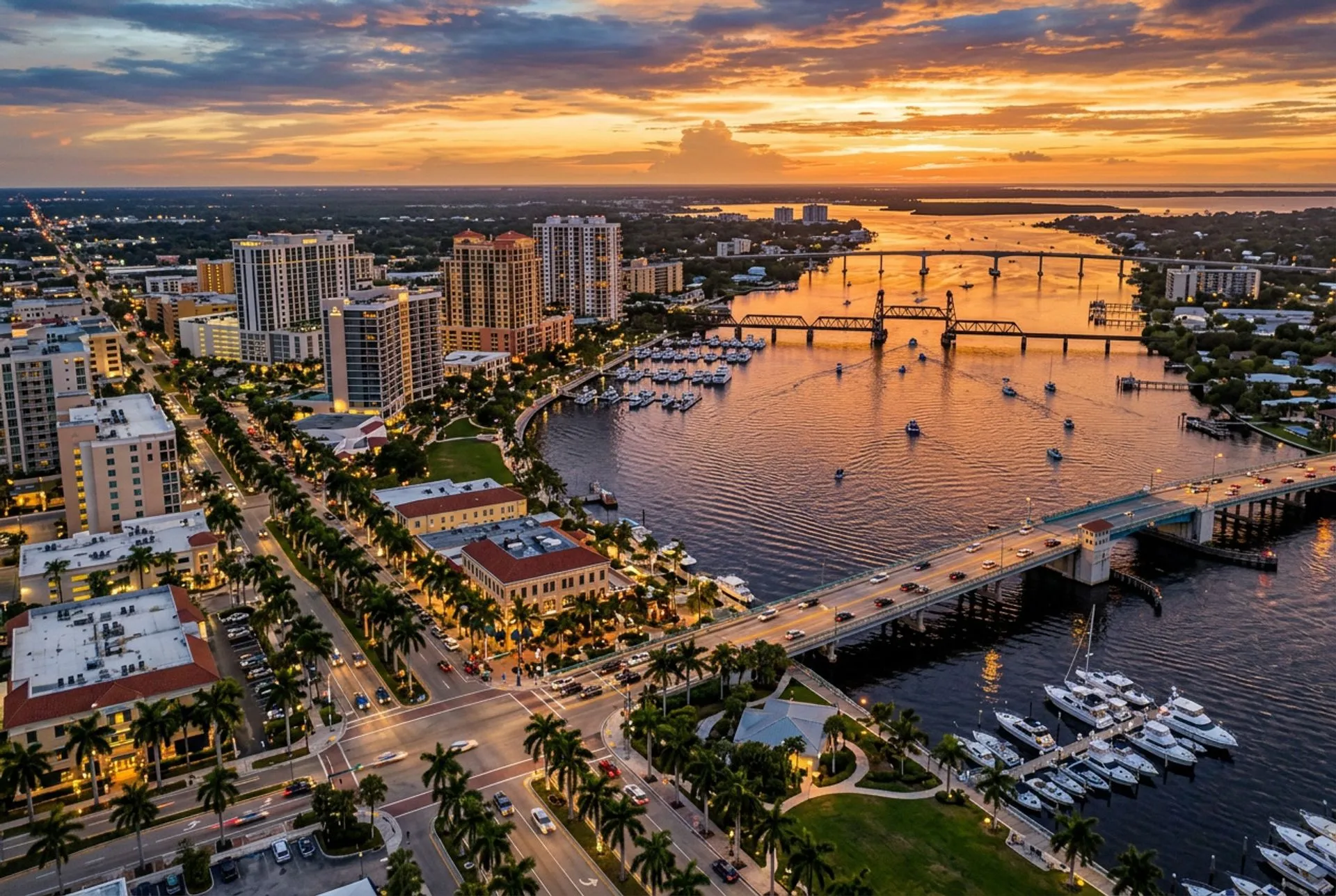 Aerial view of a vibrant Florida waterfront restaurant and bar district at golden hour with string lights and palm trees